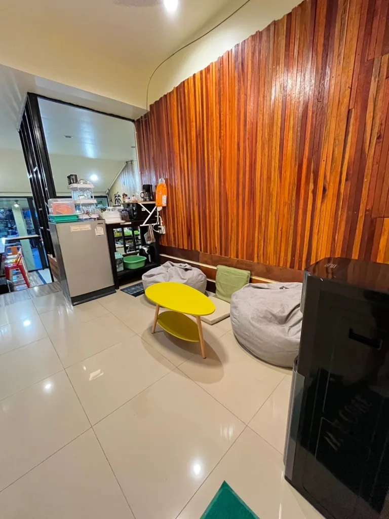 Living room, TV, and water cooler at The Cocoon Hostel - Koh Samet