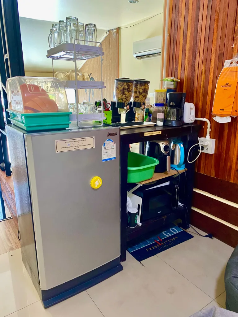 Guest kitchenette with fridge and microwave at a best value Koh Samet hostel.