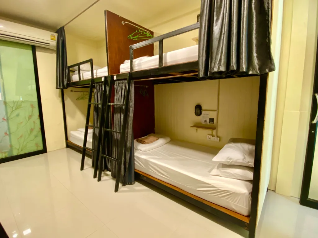 Air-conditioned dorm room with comfortable bunk beds at the best hostel in Koh Samet.