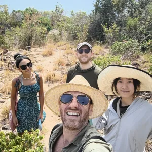 a selfie of Nick and Cocoon Hostel guests at the top of the view point on the Koh Samet Nature trail