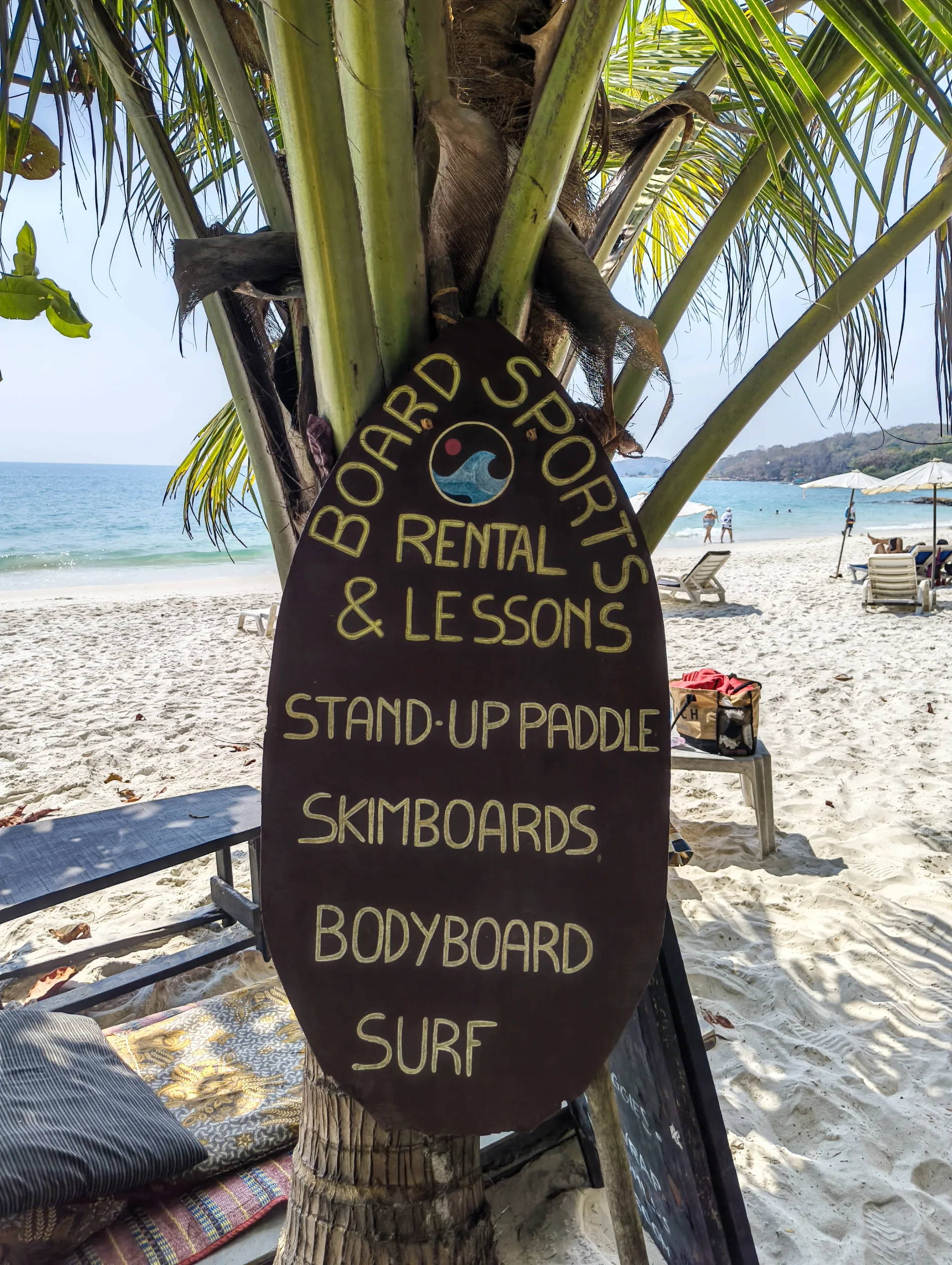 Image of the sign at flow beach advertising various watersports